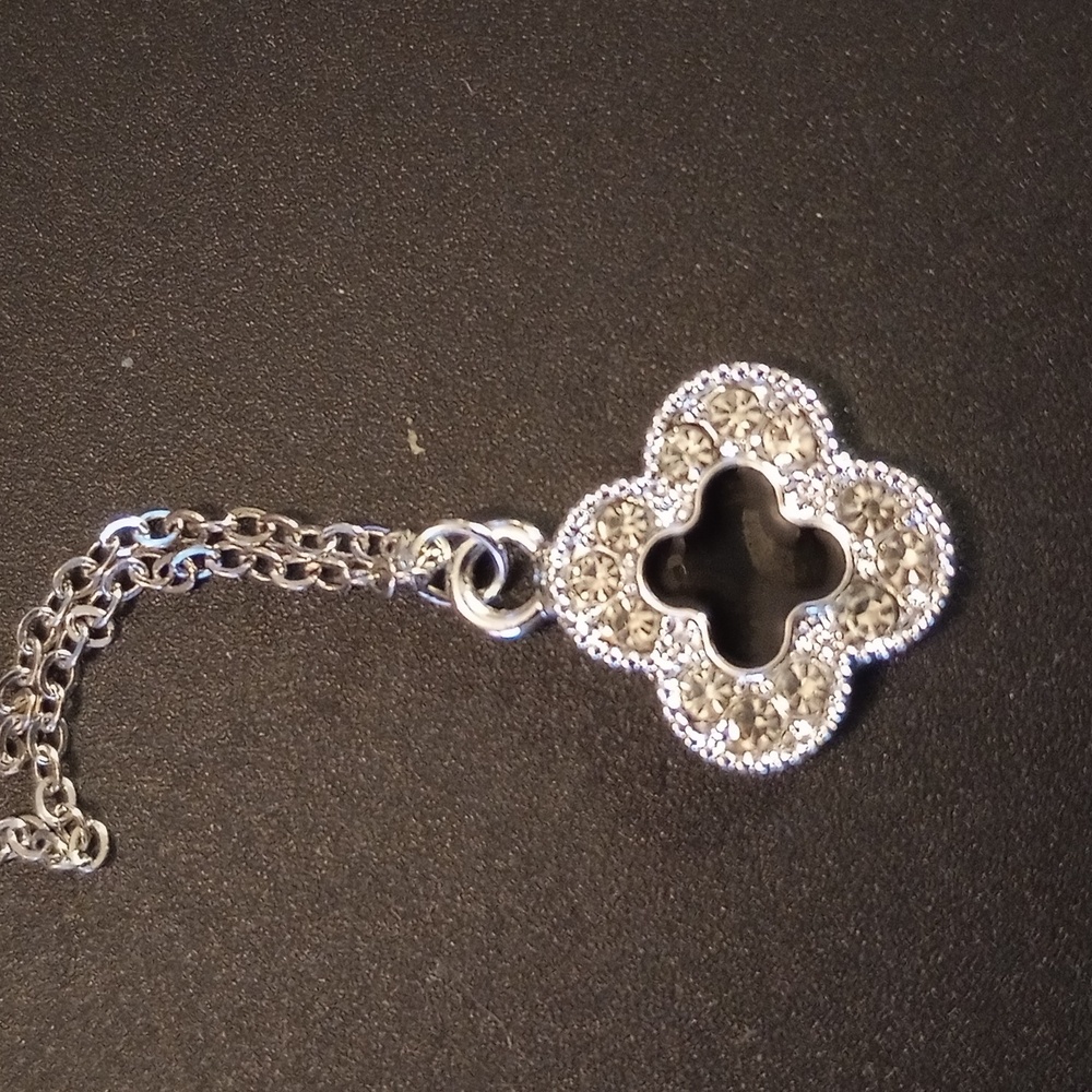Necklace clover with black in the middle and crystals around it